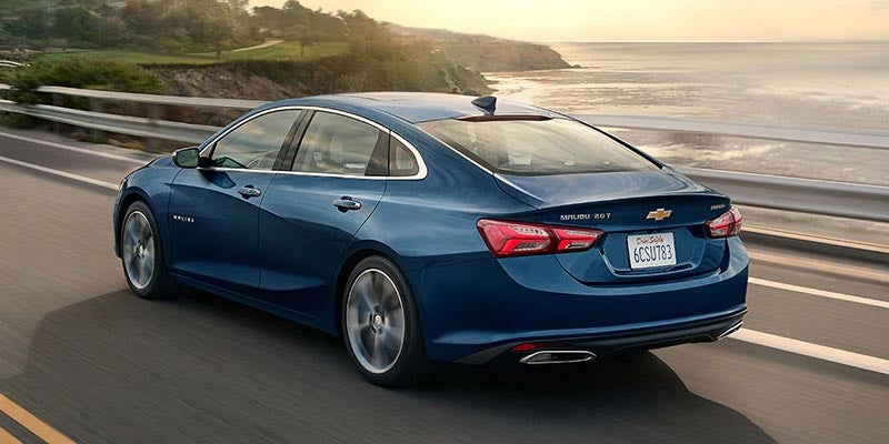 blue Chevrolet Malibu on road